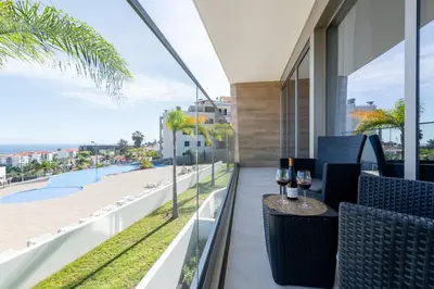 a balcony with a table with wine glasses on it at The Queen Apartment By Sam Houses in Funchal