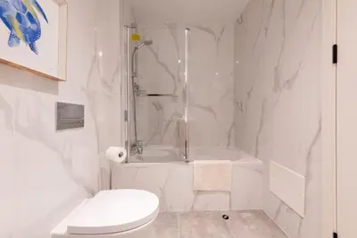 a white bathroom with a shower and a toilet at The Queen Apartment By Sam Houses in Funchal
