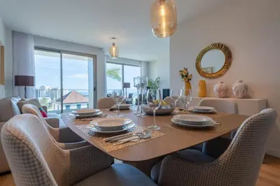 a dining room with a table with chairs and a mirror at The Queen Apartment By Sam Houses in Funchal