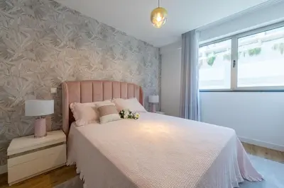 a bedroom with a pink bed and a window at The Queen Apartment By Sam Houses in Funchal