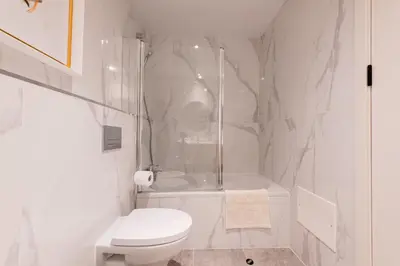 a white bathroom with a shower and a toilet at The Prince Apartment By Sam Houses in Funchal