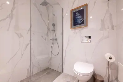 a white bathroom with a shower and a toilet at The Prince Apartment By Sam Houses in Funchal