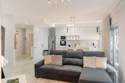 a living room with a couch and a kitchen at Doca do Cavacas I by An Island Apart in Funchal
