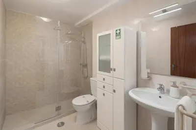 a bathroom with a toilet and a sink and a shower at Casa da Cidade by An Island Apart in Funchal