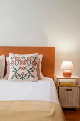 a bedroom with a bed with a pillow and a lamp at Casa da Cidade by An Island Apart in Funchal