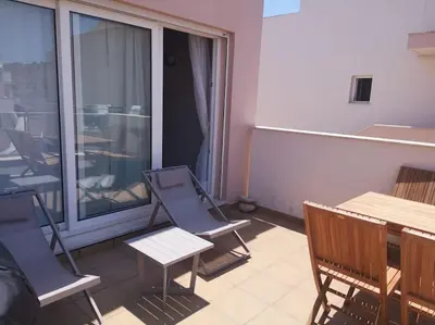 a balcony with chairs and a table and a window at Casa Sol in Burgau