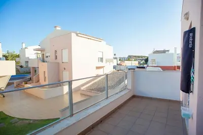a balcony with a view of a building at Casa Sol in Burgau
