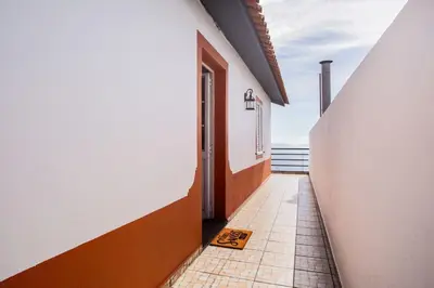 an airplane is flying over the water with buildings at Dream Paradise in Água de Pena