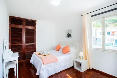 a bedroom with a bed with blue pillows and a mirror at Dream Paradise in Água de Pena