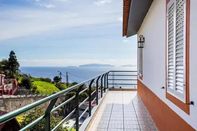 a kitchen with a black and white checkered floor at Dream Paradise in Água de Pena