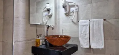 a bathroom with a bowl sink and towels at Ponta Beachside by LovelyStay in Funchal