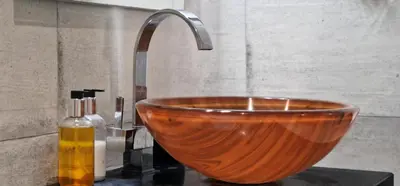 a wooden bowl sink with a faucet in a bathroom at Ponta Beachside by LovelyStay in Funchal