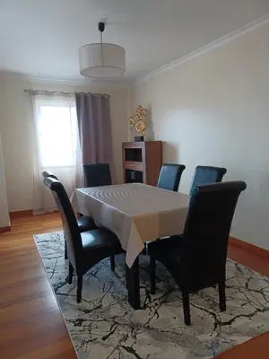 a dining room with a table and chairs and a window at Ocean Paradise Til II in Funchal