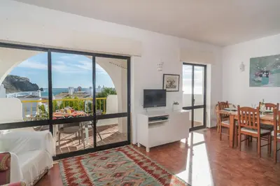 a living room with a view of the ocean at Casa da Praia in Luz