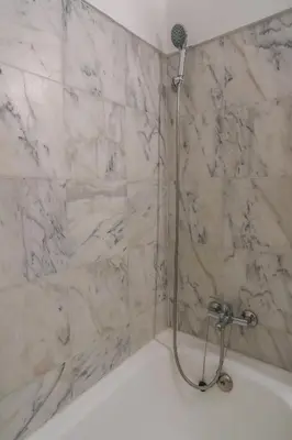 a bathroom with a shower with a bath tub at Casa da Praia in Luz