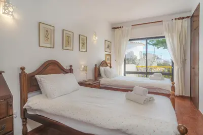 a bedroom with two beds and a window at Casa da Praia in Luz