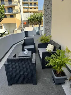 a patio with couches and plants on a building at Alforra Residence 1-T2-centro-praias-Levadas in Câmara de Lobos