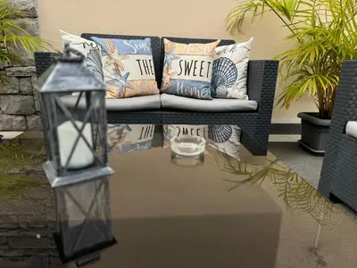 a coffee table with a couch and a candle on it at Alforra Residence 1-T2-centro-praias-Levadas in Câmara de Lobos