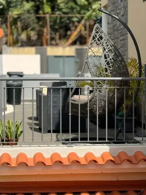 a metal chair sitting on top of a building at Alforra Residence 1-T2-centro-praias-Levadas in Câmara de Lobos