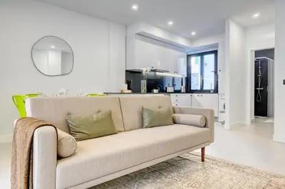 a living room with a couch and a kitchen at Beco Santa Emilia 2H, a Home in Madeira in Funchal