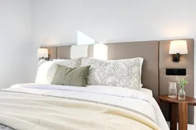 a bedroom with a large white bed with two lamps at Beco Santa Emilia 2H, a Home in Madeira in Funchal