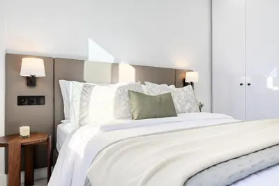 a bedroom with a large white bed with white pillows at Beco Santa Emilia 2H, a Home in Madeira in Funchal