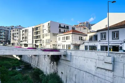 a view of a city with buildings and a bridge at Beco Santa Emilia 2H, a Home in Madeira in Funchal