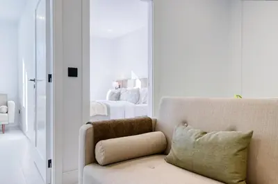 a living room with a couch and a bedroom at Beco Santa Emilia 2H, a Home in Madeira in Funchal