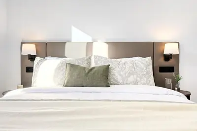 a bedroom with a large bed with white sheets and pillows at Beco Santa Emilia 2H, a Home in Madeira in Funchal