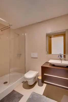 a bathroom with a toilet and a sink and a shower at Sunscape T2 in Funchal