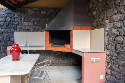 a model kitchen with a table and a stove at Sunscape T2 in Funchal