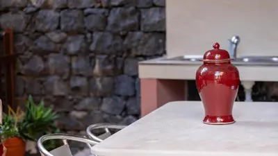 a red vase sitting on top of a table at Sunscape T2 in Funchal