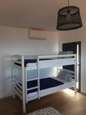 a bunk bed in a room with a ceiling at Casa dos Avós in Fajã da Ovelha