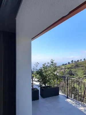 a balcony with a view of the ocean at Casa dos Avós in Fajã da Ovelha