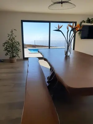 a living room with a table with a vase on it at Casa dos Avós in Fajã da Ovelha