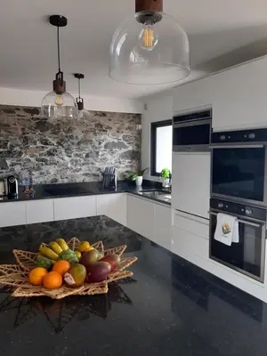 a kitchen with a bowl of fruit on the counter at Casa dos Avós in Fajã da Ovelha