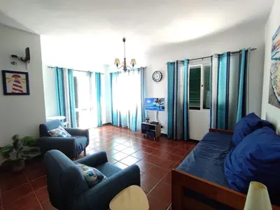 a living room with two chairs and a couch at Sunrise Holidays in Porto Santo