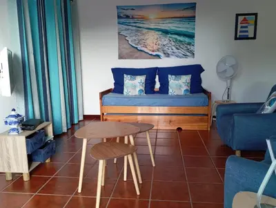 a living room with a bed and a table at Sunrise Holidays in Porto Santo