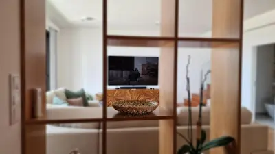 a living room with a couch and a mirror at Allure Alannas Villa by LovelyStay in Funchal