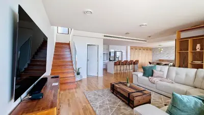 a living room with a couch and a tv at Allure Alannas Villa by LovelyStay in Funchal