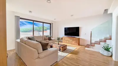 a living room with a couch and a tv at Allure Alannas Villa by LovelyStay in Funchal
