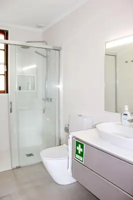 a white bed with three rolled towels on it at Casa dos Magalhães in Vila do Porto