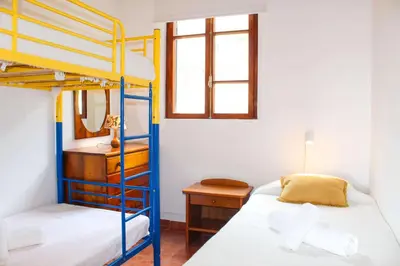 a kitchen with blue cabinets and a washing machine at Casa dos Magalhães in Vila do Porto