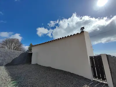 a white garage with a door on the side of it at Casa Vicente in Arco da Calheta