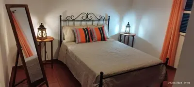 a bedroom with a bed and a mirror and a mirror at Porto Santo Island Ocean Apartment in Vila Baleira