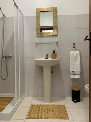 a bathroom with a sink and a shower and a mirror at Porto Santo Island Ocean Apartment in Vila Baleira