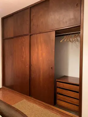 a closet with wooden doors and a wooden dresser at Porto Santo Island Ocean Apartment in Vila Baleira