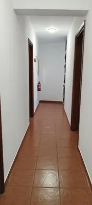 a hallway with white walls and a tile floor at Porto Santo Island Ocean Apartment in Vila Baleira