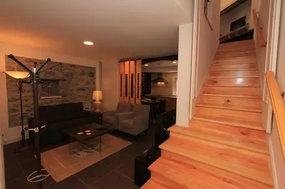 a living room with a staircase and a couch at Guest house Santa Maria in Funchal
