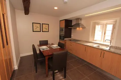 a kitchen with a wooden table and a kitchen with a sink at Guest house Santa Maria in Funchal